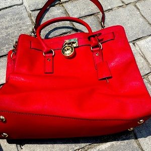 Micheal Kors  LARGE Bright red tote with handles and shoulder strap.